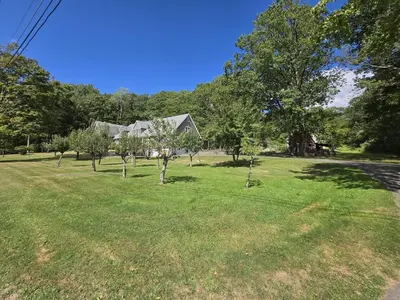 a large yard with trees and a house at Honesdale in Honesdale