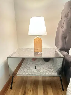 a lamp on a glass table next to a chair at Honesdale in Honesdale