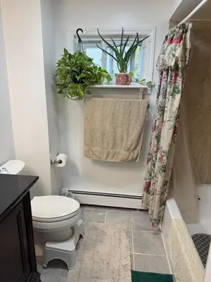 a bathroom with a toilet and a window at BedRoom with half bathroom in Ridgefield Park