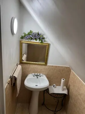 a bathroom with a sink and a mirror at BedRoom with half bathroom in Ridgefield Park