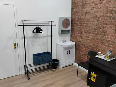 a bathroom with a sink and a brick wall at Aycee 417 in New York