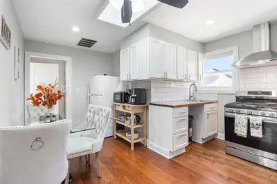 a kitchen with white appliances and a table and chairs at Lacoco Suite in Roselle