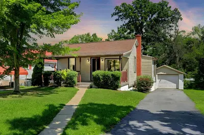 a house with a grass yard and a driveway at Stay on State in Duncannon