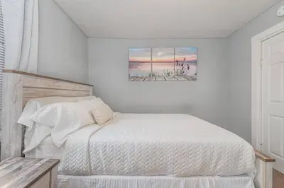 a bedroom with a bed and a painting on the wall at Stay on State in Duncannon