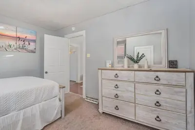 a bedroom with a dresser and a mirror at Stay on State in Duncannon