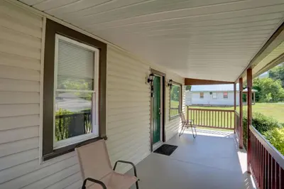 a porch with two chairs and a window at Stay on State in Duncannon