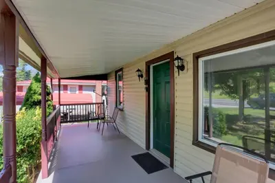a porch of a house with a green door at Stay on State in Duncannon