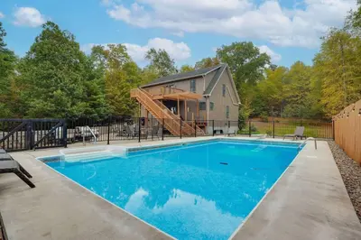 a swimming pool in front of a house at Happy Trails House in Liverpool