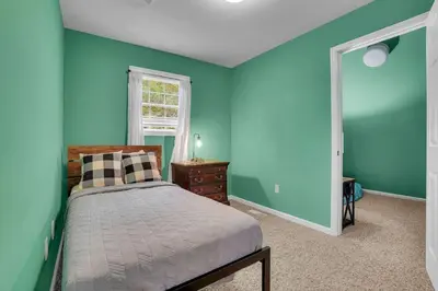 a bedroom with blue walls and a bed and a window at Happy Trails House in Liverpool