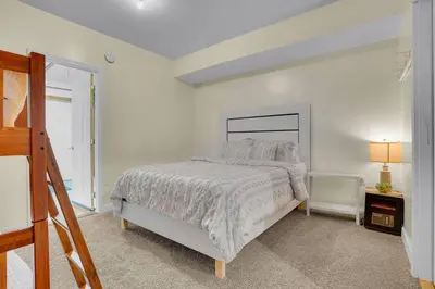 a white bedroom with a bed and a window at Happy Trails House in Liverpool
