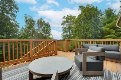 a deck with a couch and a table on a deck at Happy Trails House in Liverpool