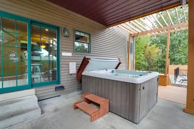 a hot tub sitting on the side of a house at Happy Trails House in Liverpool