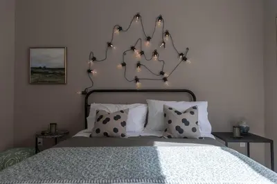 a bedroom with a bed with lights on it at An Locha B&B