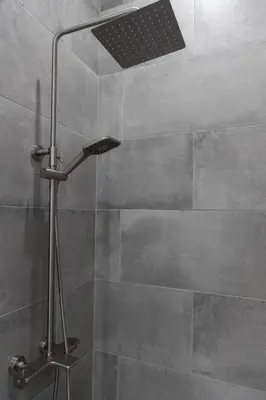 a shower with a shower head in a bathroom at An Locha B&B