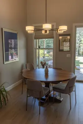 a dining room with a wooden table and chairs at An Locha B&B