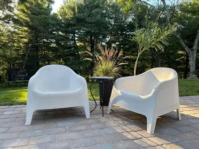 two white chairs sitting on top of a patio at An Locha B&B