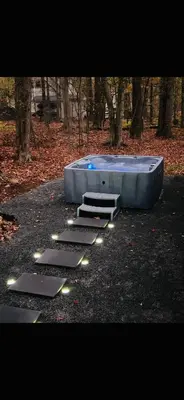 a swimming pool with a stairs in a park at Lake Access, Hot Tub, Fire Pit in Arrowhead Lake