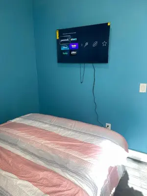 a bedroom with a bed and a tv on the wall at Peace Sterling Haven in Newark