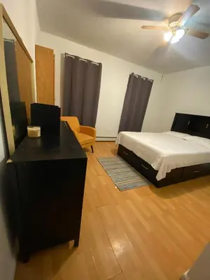 a bedroom with a bed and a desk and a chair at Private Room near NYC! in Paterson