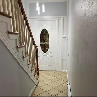 a hallway with a white door with a round window at Private Room near NYC! in Paterson