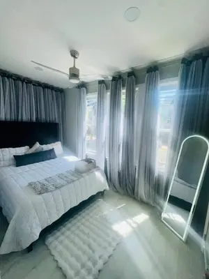 a bedroom with a bed and a chair and a window at 3 Large Bedrooms Luxe Artistic Art Vibe in Newark