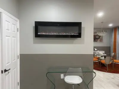 a living room with a tv on a wall at 3 Large Bedrooms Luxe Artistic Art Vibe in Newark