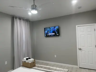 a living room with a tv on the wall at 3 Large Bedrooms Luxe Artistic Art Vibe in Newark