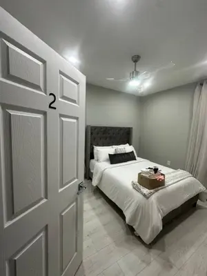 a bedroom with a bed and a white door at 3 Large Bedrooms Luxe Artistic Art Vibe in Newark