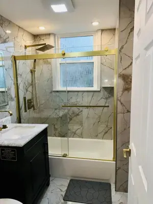 a bathroom with a shower with a glass door at 3 Large Bedroom Designer house Spacious in Newark