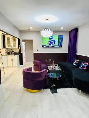 a living room with purple chairs and a couch at 3 Large Bedroom Designer house Spacious in Newark