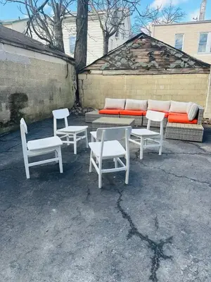 a group of white chairs and a table and a couch at 3 Large Bedroom Designer house Spacious in Newark