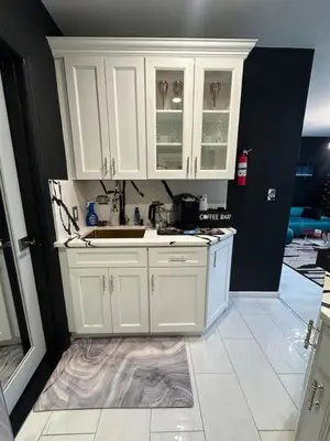a kitchen with white cabinets and a sink at 1 Large Bedroom Contemporary Luxe Stay in Newark