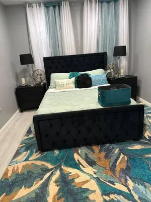 a black cat laying on a bed in a bedroom at 1 Large Bedroom Contemporary Luxe Stay in Newark