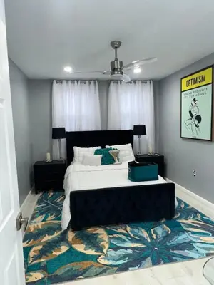 a bedroom with a large bed and a rug at 1 Large Bedroom Contemporary Luxe Stay in Newark