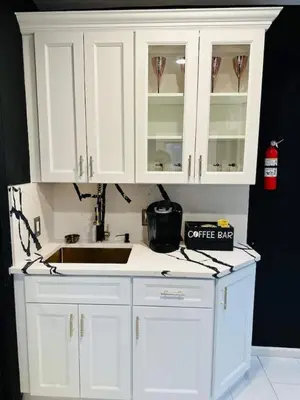 a kitchen with white cabinets and a coffee bar at 1 Large Bedroom Contemporary Luxe Stay in Newark