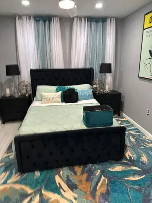 a black cat laying on a bed in a bedroom at 1 Large Bedroom Contemporary Luxe Stay in Newark