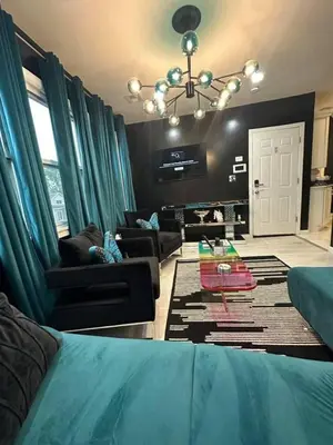a living room with a bed and a couch at 1 Large Bedroom Contemporary Luxe Stay in Newark