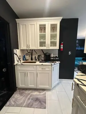 a kitchen with white cabinets and a white tile floor at 7 Large Bedrooms Art-Inspired Art House in Newark