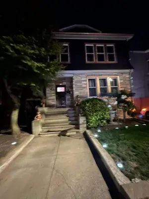 a house at night with a person standing in front of it at 7 Large Bedrooms Art-Inspired Art House in Newark