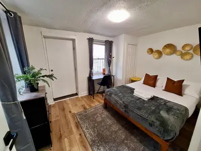 a bedroom with a bed and a desk in it at Brand New 1BR in Center City with Private Backyard in Philadelphia
