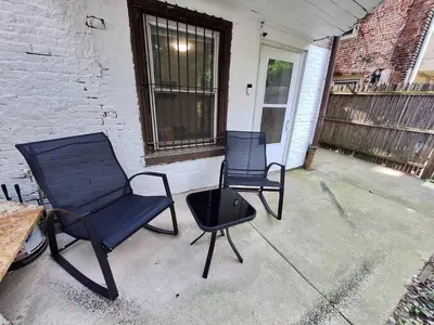 two chairs and a table on a patio at Brand New 1BR in Center City with Private Backyard in Philadelphia