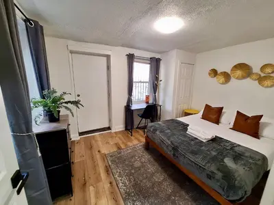a bedroom with a large bed and a window at Brand New 1BR in Center City with Private Backyard in Philadelphia
