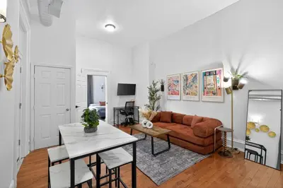 a living room with a couch and a table at Large 1 BR in Center City with Double Queen Beds and King Sleeper Sofa) in Philadelphia