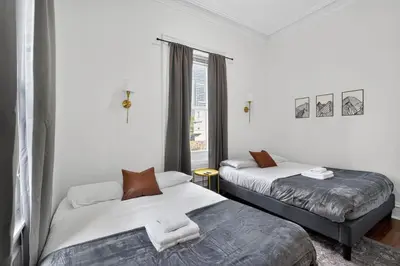 a bedroom with two beds and a window at Large 1 BR in Center City with Double Queen Beds and King Sleeper Sofa) in Philadelphia