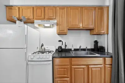 a kitchen with a white refrigerator and a sink at Large 1 BR in Center City with Double Queen Beds and King Sleeper Sofa) in Philadelphia