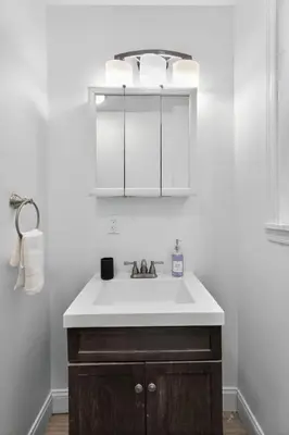 a bathroom with a white sink and a mirror at Large 1 BR in Center City with Double Queen Beds and King Sleeper Sofa) in Philadelphia