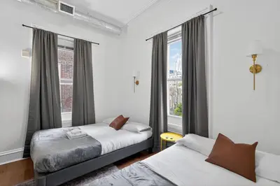 a bedroom with two beds and a window at Large 1 BR in Center City with Double Queen Beds and King Sleeper Sofa) in Philadelphia