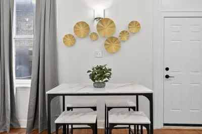a dining room with a table and two umbrellas on the wall at Large 1 BR in Center City with Double Queen Beds and King Sleeper Sofa) in Philadelphia