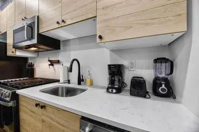 a kitchen with a sink and a counter top at Brand New 2BR in the Heart of Center City that Sleeps 14 people in Philadelphia
