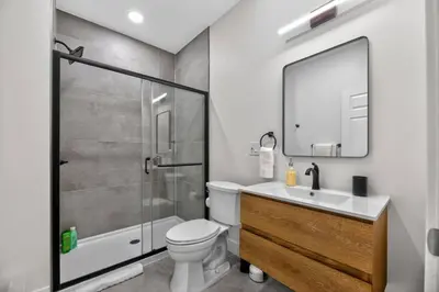 a bathroom with a shower and a toilet and a sink at Brand New 2BR in the Heart of Center City that Sleeps 14 people in Philadelphia